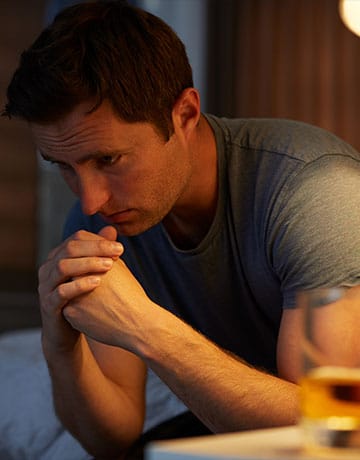 sober living outcomes | alcholic alone depressed contemplating taking a drink