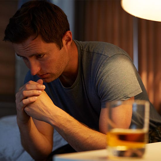 sober living outcomes | alcholic alone depressed contemplating taking a drink mobile